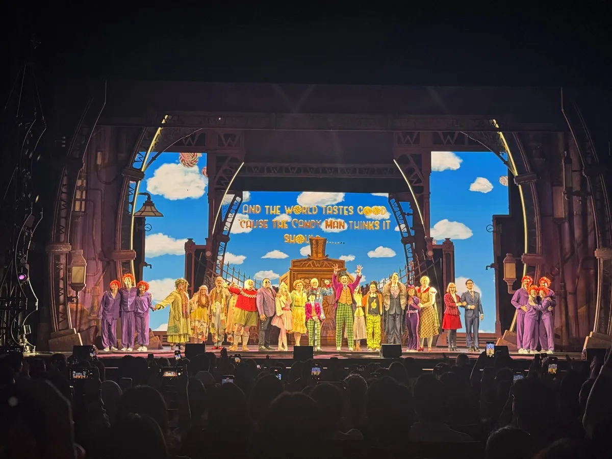 Cast taking a curtain call on stage